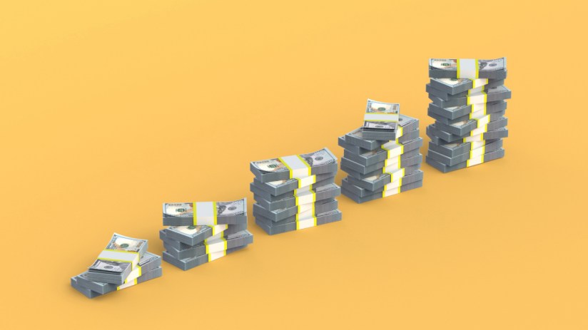 Stack of hundred-dollar bills symbolizing wealth and economic growth in the financial news context