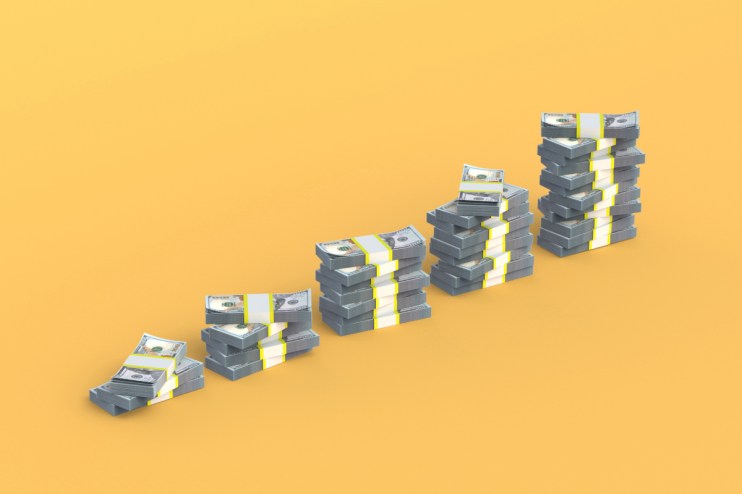 Stack of hundred-dollar bills symbolizing wealth and economic growth in the financial news context