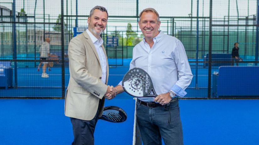 Players compete in an intense padel match on a vibrant court, showcasing skill and teamwork in a popular sports competition.