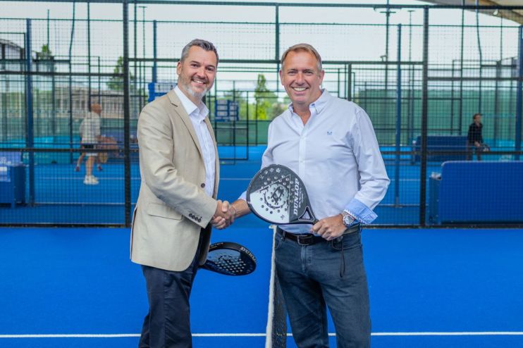 Players compete in an intense padel match on a vibrant court, showcasing skill and teamwork in a popular sports competition.