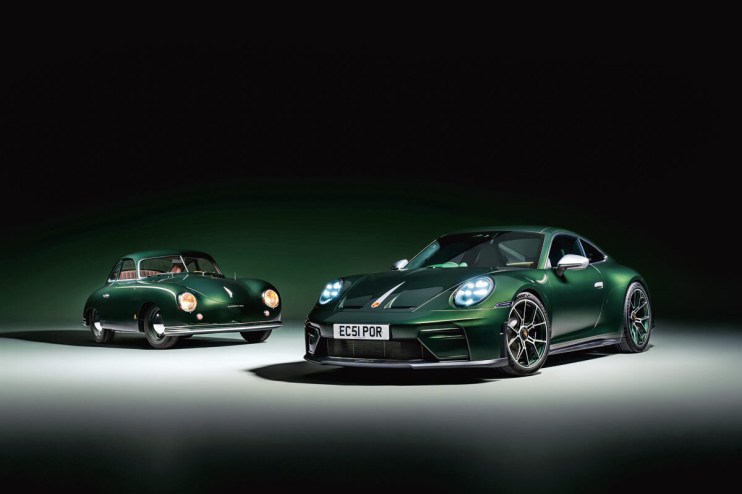 Porsche 911 parked at a city street, showcasing its sleek design and iconic curves under bright daylight.