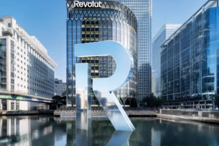 Revolut London office glass facade with prominent R logo reflecting cityscape, highlighting modern fintech design