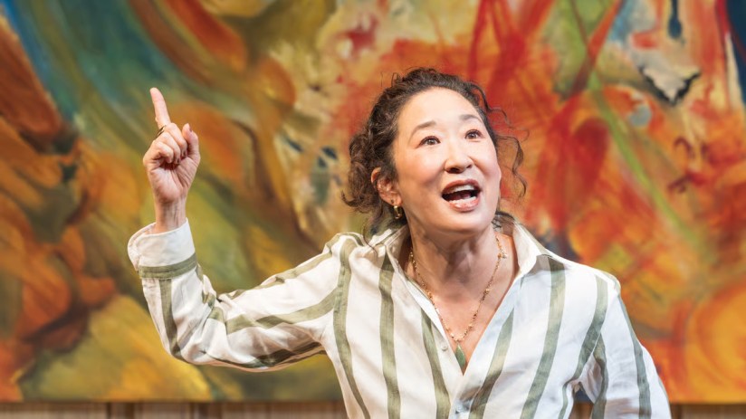 Sandra Oh performing in The Misanthrope play, showcasing a dramatic scene with expressive gestures on stage.