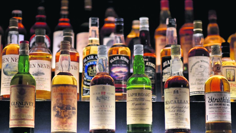 Assortment of various Scotch whisky bottles including Glenlivet, Glenmorangie, Lagavulin, Laphroaig, and Macallan.