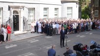 Andy Burnham speaking to media outside 10 Downing Street with a crowd gathered.