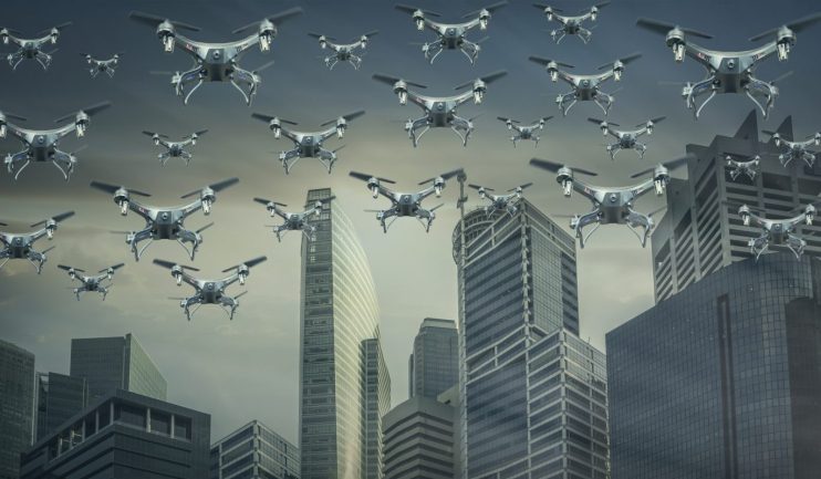 Swarm of AI-powered drones flying over a city skyline, symbolizing modern warfare and autonomous technology.