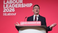 Andy Burnham speaking at Labour leadership event, addressing the audience with confidence and engaging in political discou...