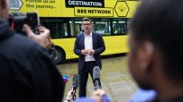 Andy Burnham discussing Manchesters Bee Network public transport initiative at a city council event.