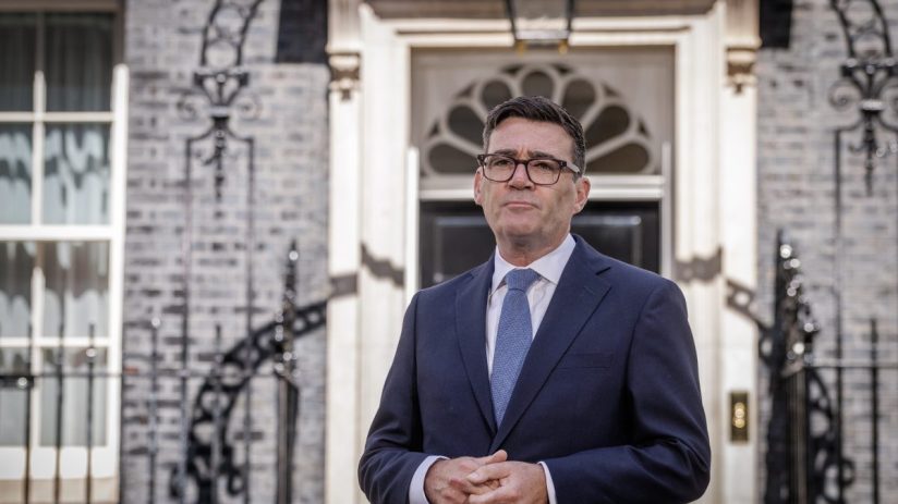 Andy Burnham, Mayor of Greater Manchester, standing outside 10 Downing Street in a suit and tie.