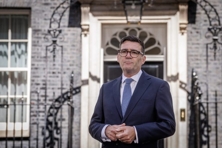 Andy Burnham, Mayor of Greater Manchester, standing outside 10 Downing Street in a suit and tie.
