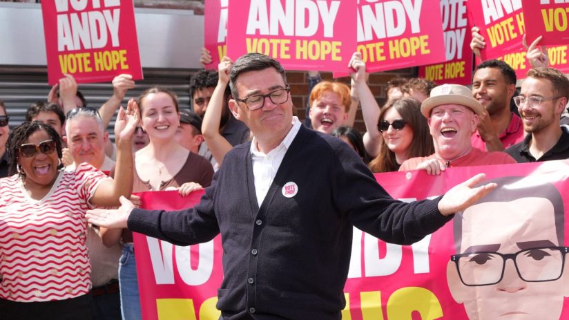 Andy Burnham supporters rallying with banners and signs at a political event, showcasing enthusiasm and solidarity