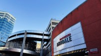 Manchester Arndale shopping centre entrance with Manchester Arndale sign, red brick, and modern glass buildings.