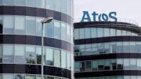 Atos logo prominently displayed on a modern office building, highlighting its corporate presence and technological expertise.