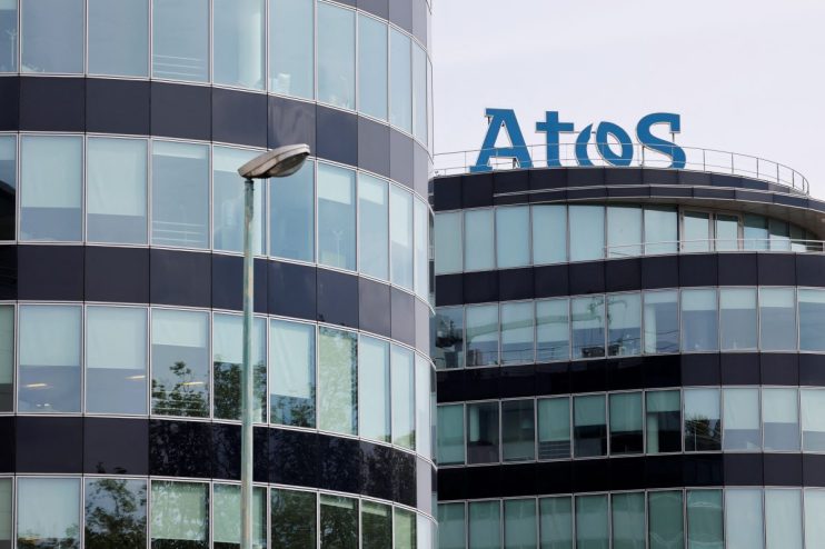 Atos logo prominently displayed on a modern office building, highlighting its corporate presence and technological expertise.