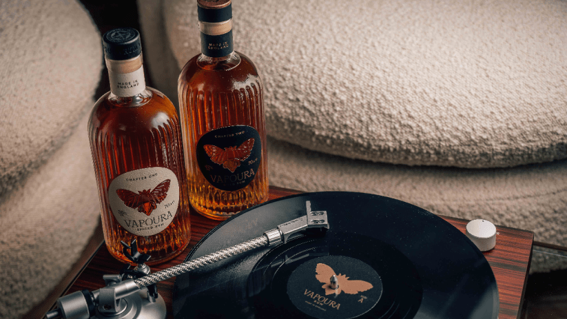 Vinyl records and Vapoura bottles arranged on a wooden shelf, showcasing a blend of music and vintage decor elements