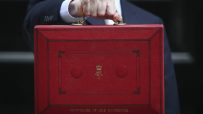 Chancellor holding iconic red budget box outside Downing Street, symbolizing UKs annual budget announcement