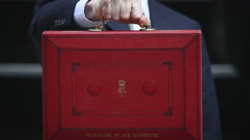 Chancellor holding iconic red budget box outside Downing Street, symbolizing UKs annual budget announcement