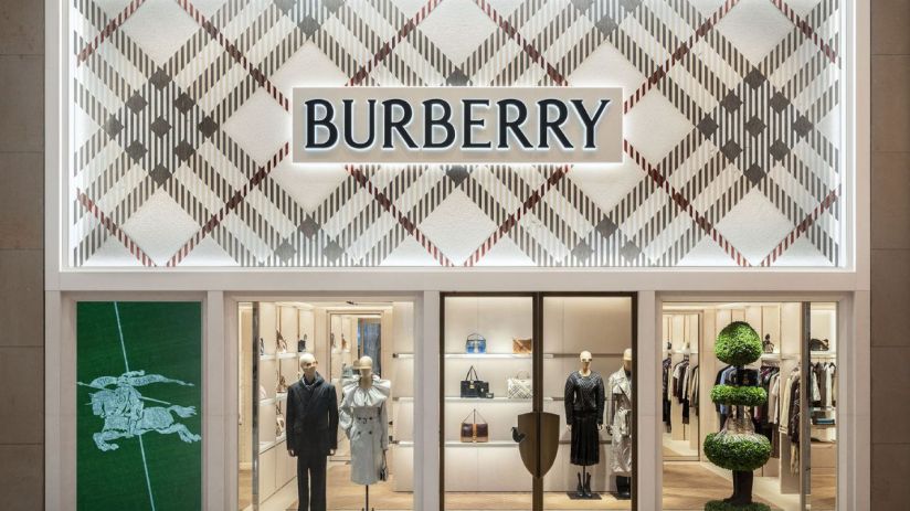 Burberry store facade with classic plaid pattern, logo, display windows featuring mannequins and handbags