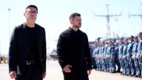Andy Burnham and Volodymyr Zelenskyy walking, with uniformed military personnel in background.