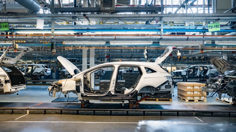 Car bodies on an assembly line in a UK car plant, showcasing EV manufacturing process