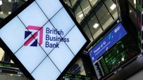 British Business Bank 10th anniversary celebration featuring executives, commemorative banners, and festive decor