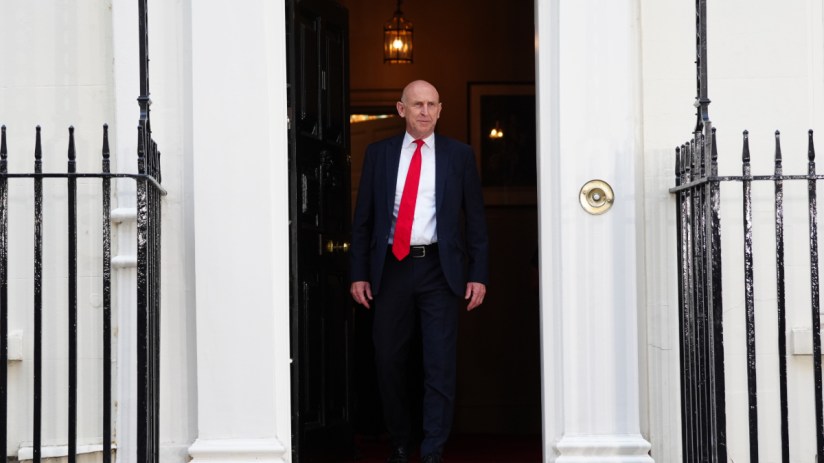 Chancellor John Healey speaking at a professional event, likely a press conference or address.