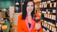 Claret wine bottles displayed on a wooden shelf, showcasing diverse labels and changing trends in the wine industry