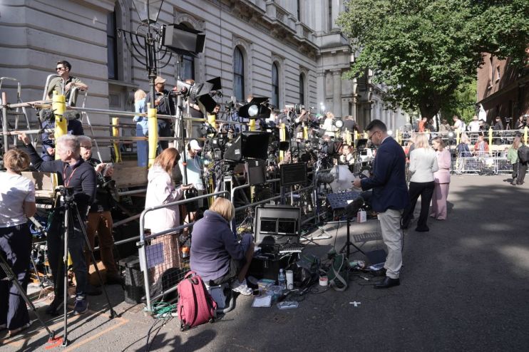 Downing Street entrance with iconic black door, relevant to UK government and politics, set in a historic London street scene