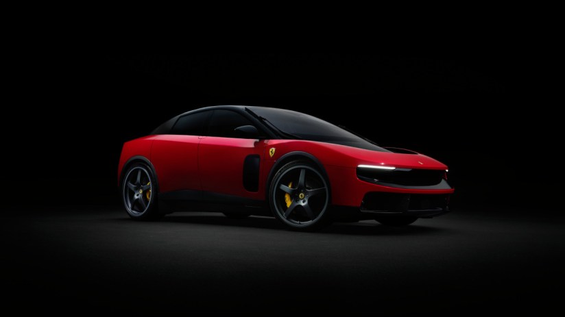Red Ferrari Luce concept car with black roof and wheels, yellow brake calipers, against a dark background.