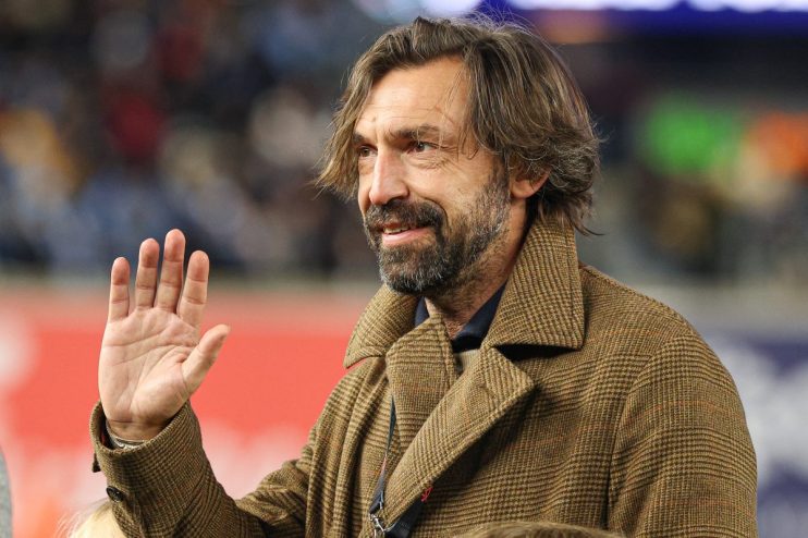 Andrea Pirlo, former Italian footballer, waving to the crowd in a brown tweed coat.
