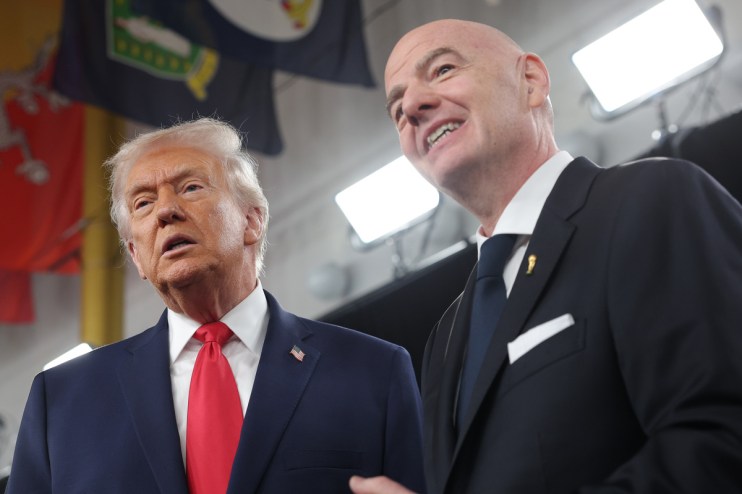 Donald Trump and FIFA President Gianni Infantino smiling, looking upwards during an event.