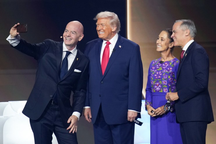 Gianni Infantino takes a selfie with Donald Trump, Claudia Sheinbaum, and a man in a suit.