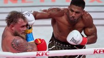 Anthony Joshua landing a punch on Jake Paul during a boxing match