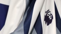 Close-up of a white and navy blue sports jersey with the Premier League logo emblem on the fabric