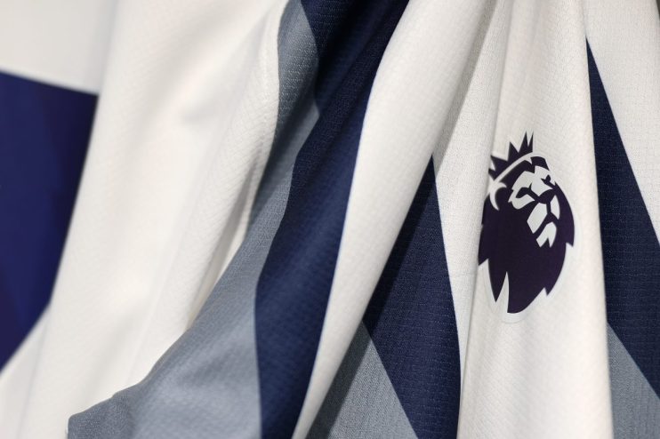 Close-up of a white and navy blue sports jersey with the Premier League logo emblem on the fabric