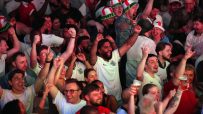 Brits celebrating in a pub, raising pints during England vs Mexico World Cup match, highlighting hospitality boost