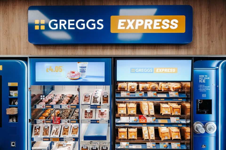 Greggs Express signage above a self-service kiosk displaying donuts, pastries, and sandwiches