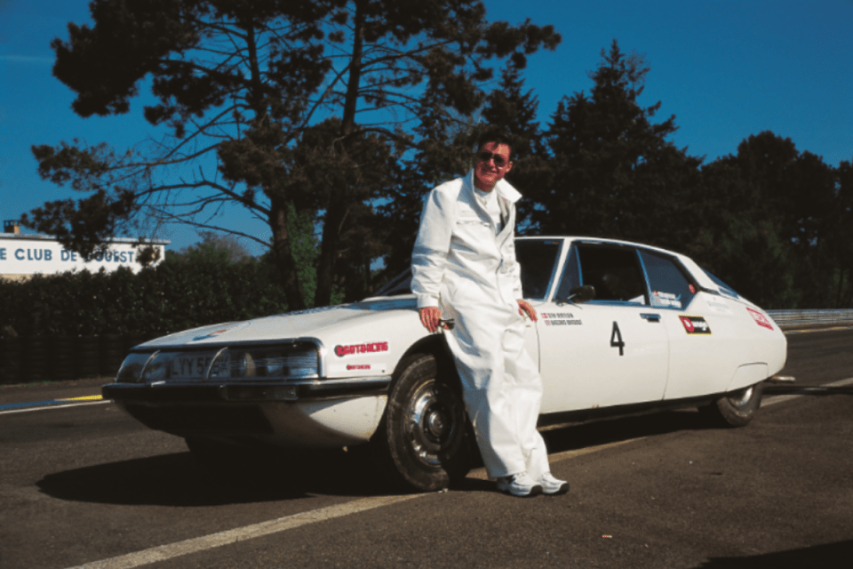 Gumball 3000 rally featuring luxury cars on a scenic route, highlighting vibrant designs and enthusiastic crowds