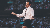 Harry Styles performing on stage at Wembley Stadium, capturing the excitement of a live concert with a vibrant crowd in at...