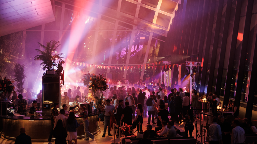 Guests enjoying vibrant Havana Sky Garden party with colorful decorations and lively atmosphere