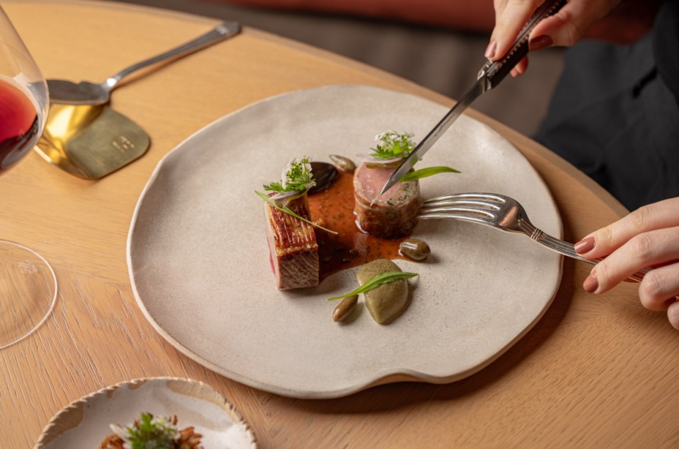 Helene Darroze Spring 26 dish by Justin De Souza: perfectly cooked meat being cut with a knife and fork