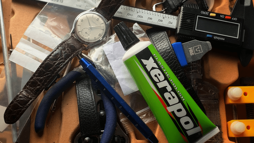 Collection of vintage watches displayed on a wooden table, showcasing diverse brands and styles for collectors