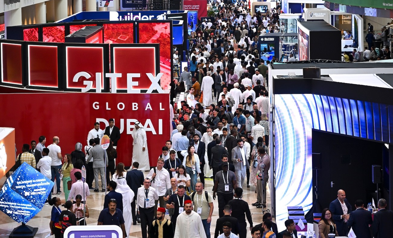 Crowd of diverse attendees at GITEX GLOBAL DUBAI tech exhibition, with GITEX signage visible.