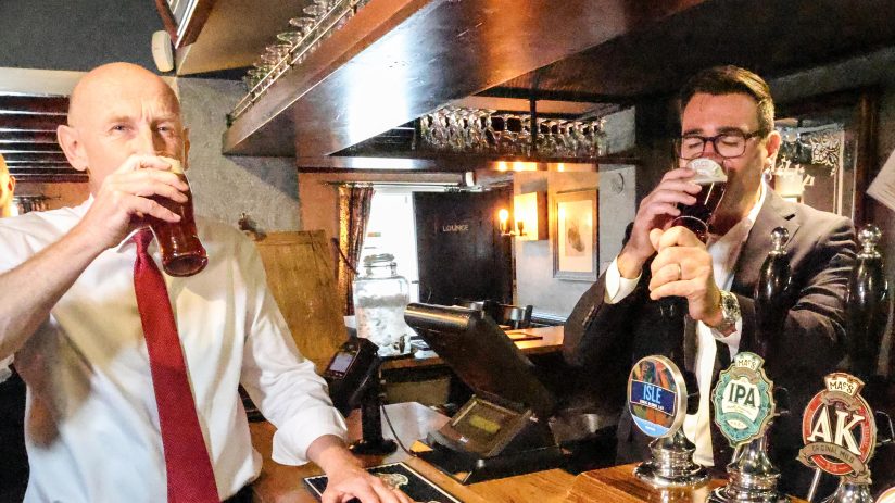 John Healey and Andy Burnham sampling beers at a pub bar
