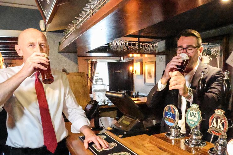 John Healey and Andy Burnham sampling beers at a pub bar