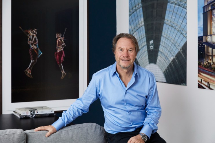 John Hitchox, founder of YOO Group, in a professional setting discussing innovative design and architecture strategies.