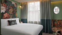 Luxurious Kensington Hideaway room featuring elegant decor, plush furnishings, and ambient lighting for a sophisticated re...