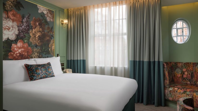 Luxurious Kensington Hideaway room featuring elegant decor, plush furnishings, and ambient lighting for a sophisticated re...