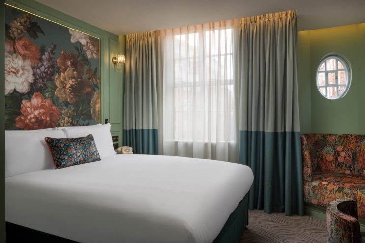 Luxurious Kensington Hideaway room featuring elegant decor, plush furnishings, and ambient lighting for a sophisticated re...
