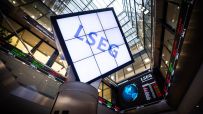 LSEG logo on a large screen inside a modern building with stock tickers and glass ceilings.